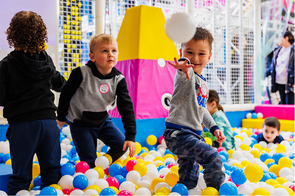 Young children playing in a colourful ball pit in the miniBOUNCE junior zone at BOUNCE Homebush.