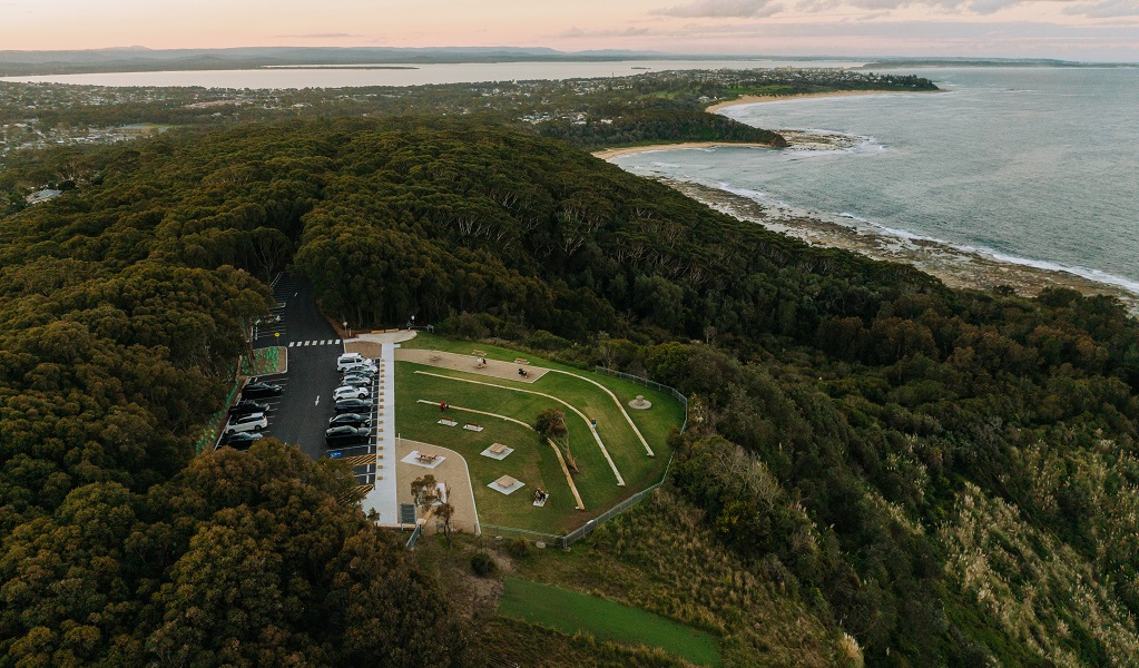 Aerial view of the Crackneck Point Lookout clifftop, lawn and carpark above the ocean at Bateau Bay