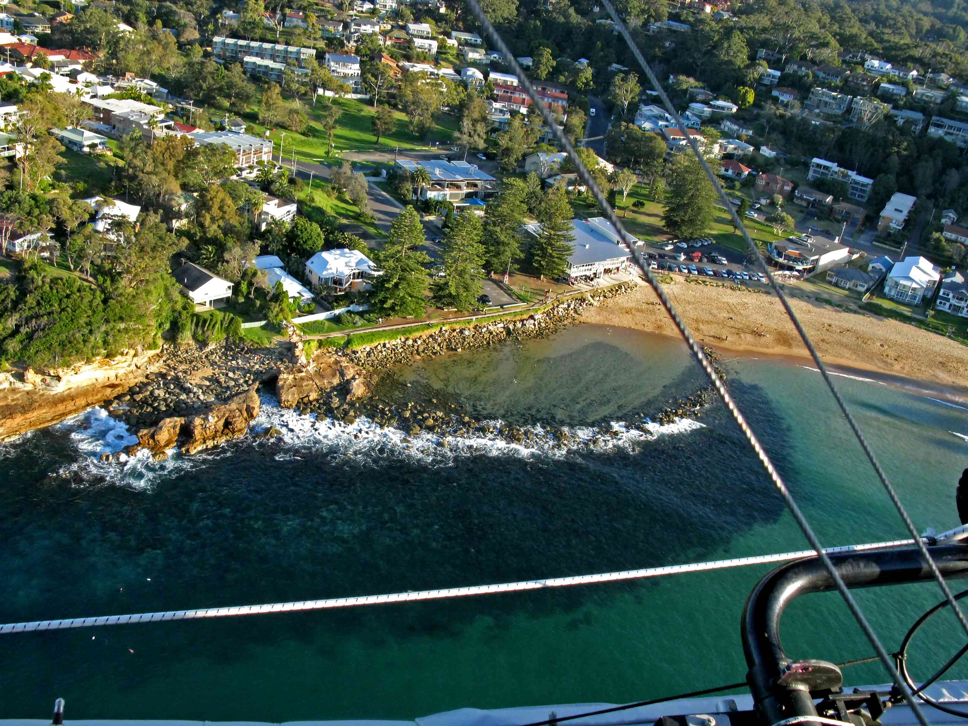 Aerial view of the Avoca Beach rock pool beside the surf beach.