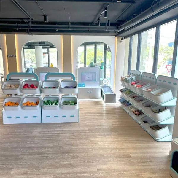 Modern children's activity center with white modular storage units displaying colorful toys and materials, featuring bright open space with large windows and industrial ceiling.