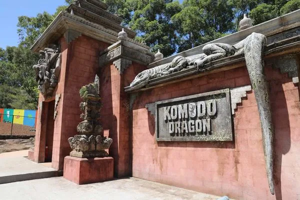 Entrance gate to Komodo Dragon exhibit featuring traditional Indonesian-style red brick architecture with carved stone dragon sculptures and decorative pillars