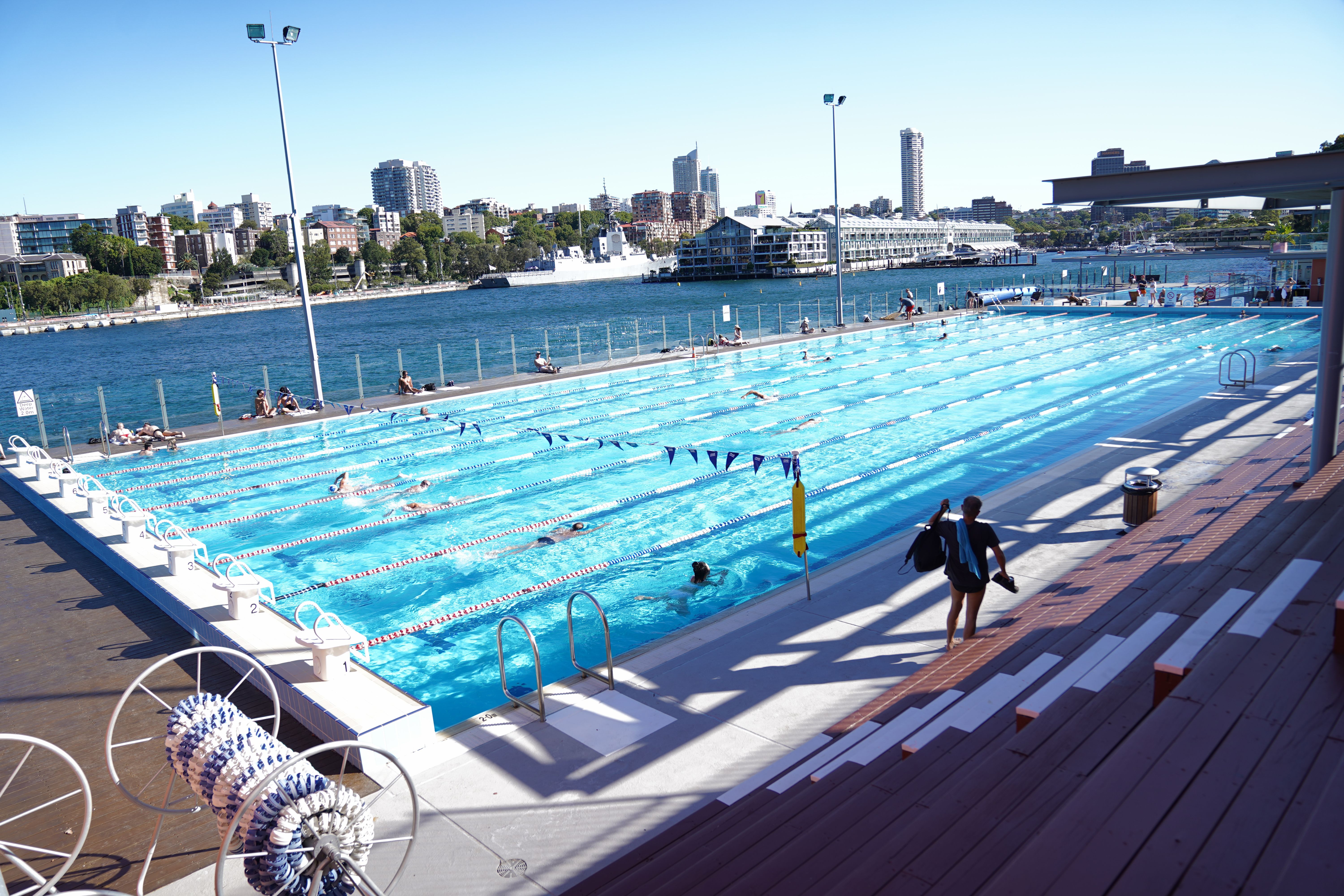 Swimmers and harbour views at Andrew (Boy) Charlton Pool, Sydney.