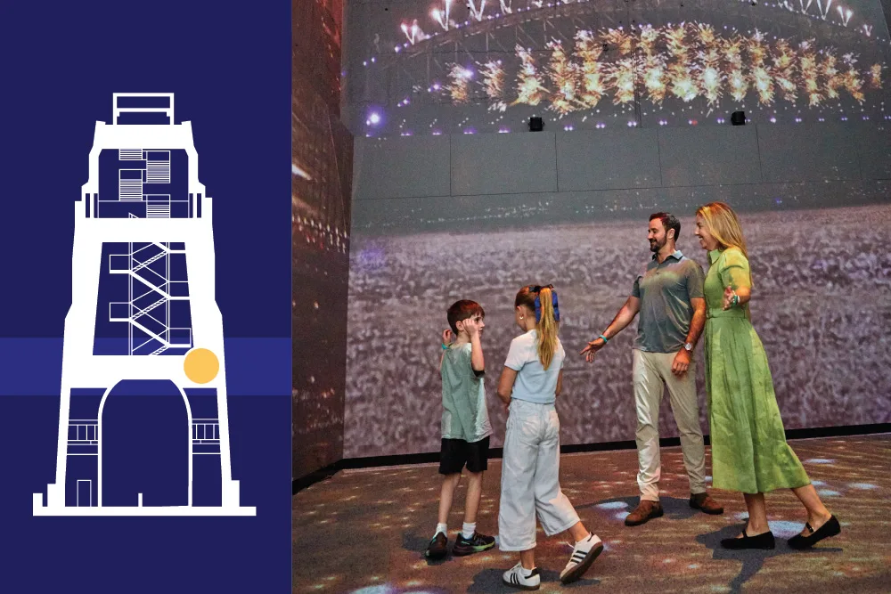 Family of four explores interactive Sydney Harbour Bridge museum exhibit with illuminated bridge display and projected harbor views overhead