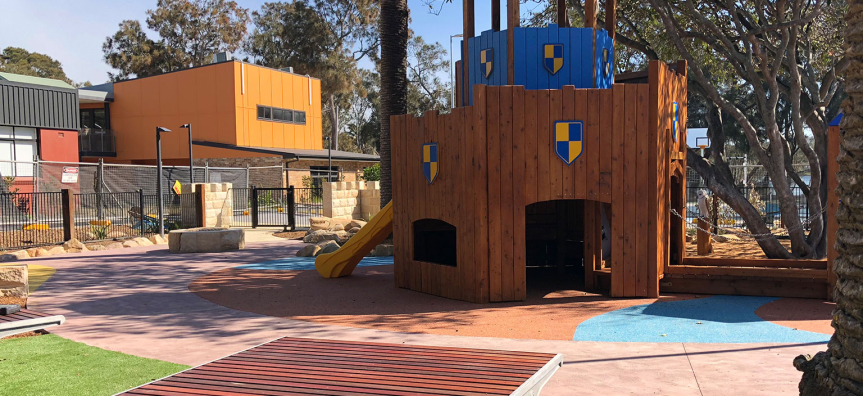 Berry Reserve Playground, the fenced castle-themed playground beside Narrabeen Lagoon