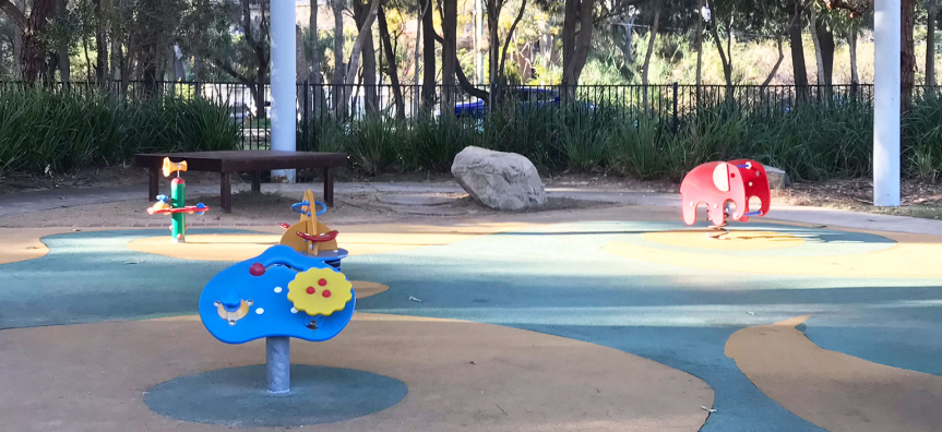 Bilarong Reserve playground equipment on the grassy foreshore at North Narrabeen.